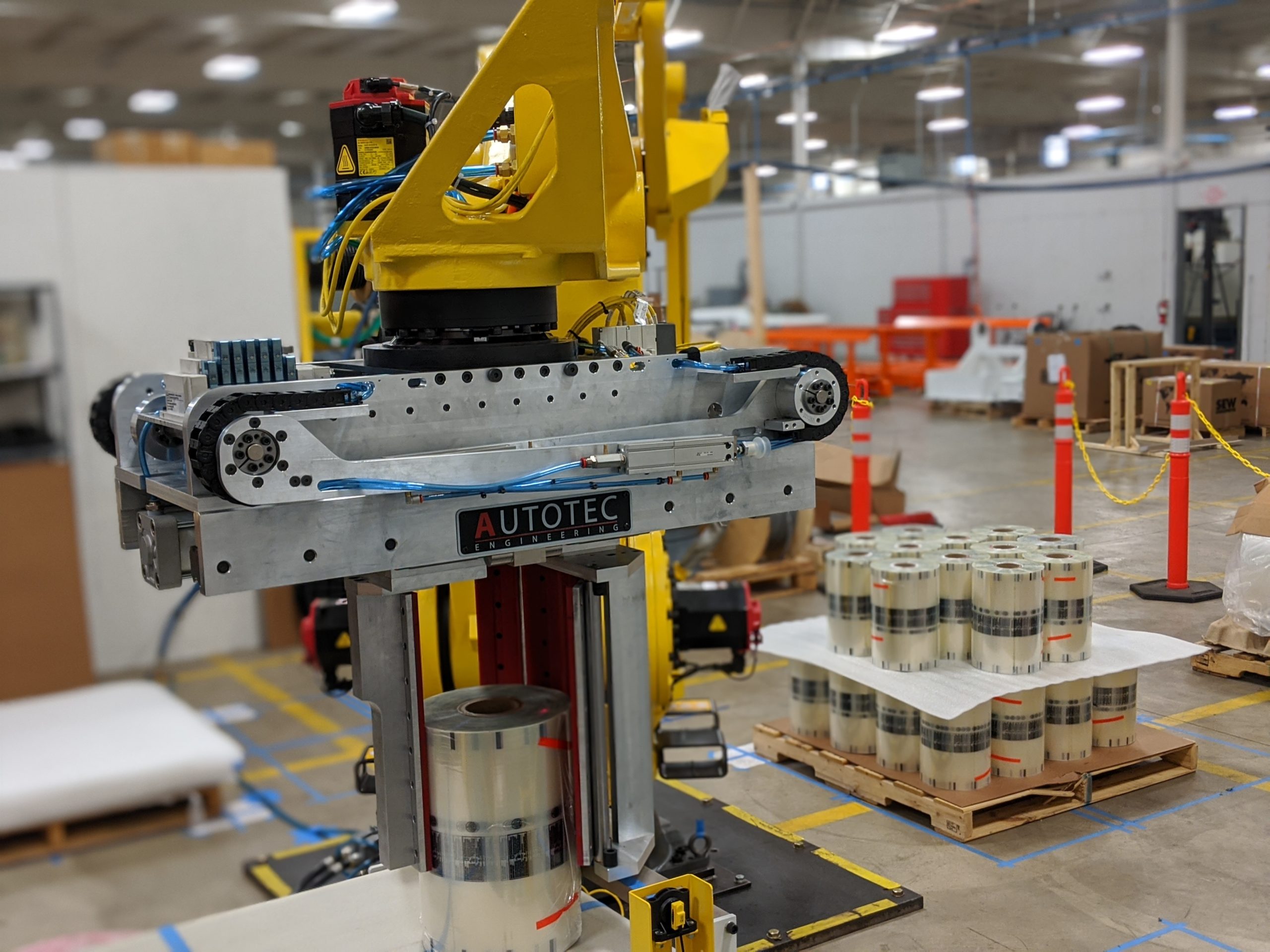 Autotec Solutions Automated Roll Handling End-of-Arm tool with integrated RFID scanning technology and Fanuc Robot in background